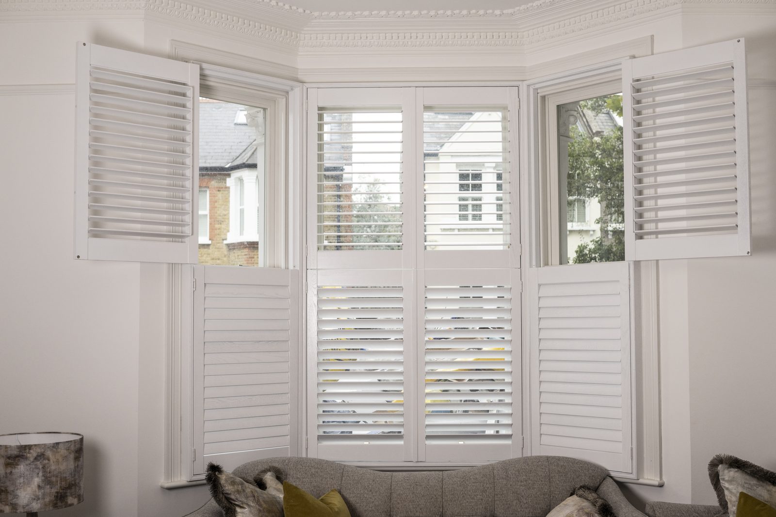 Tier-on-tier bay window shutters in a Suffolk bay