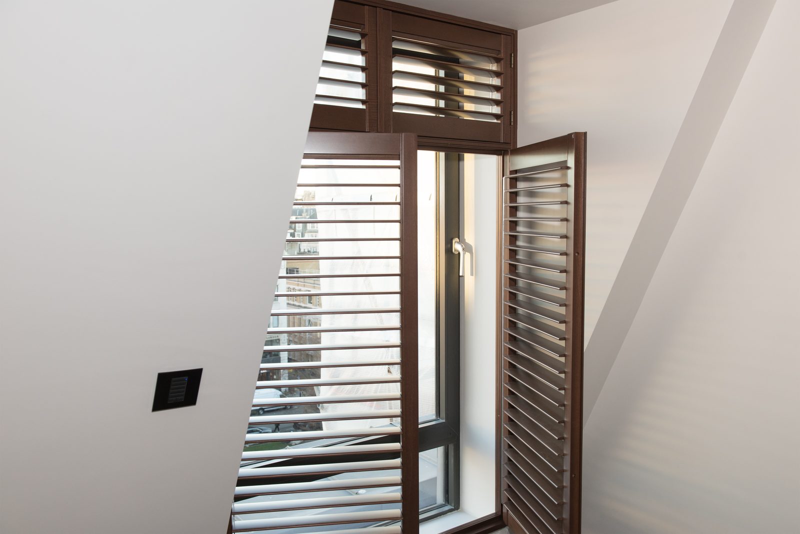 Wooden shutters on a stairwell window in Ipswich