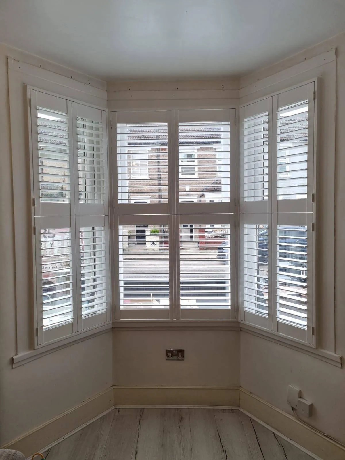 Tier-on-tier shutters with independently opening top and bottom panels on an Ipswich bay window
