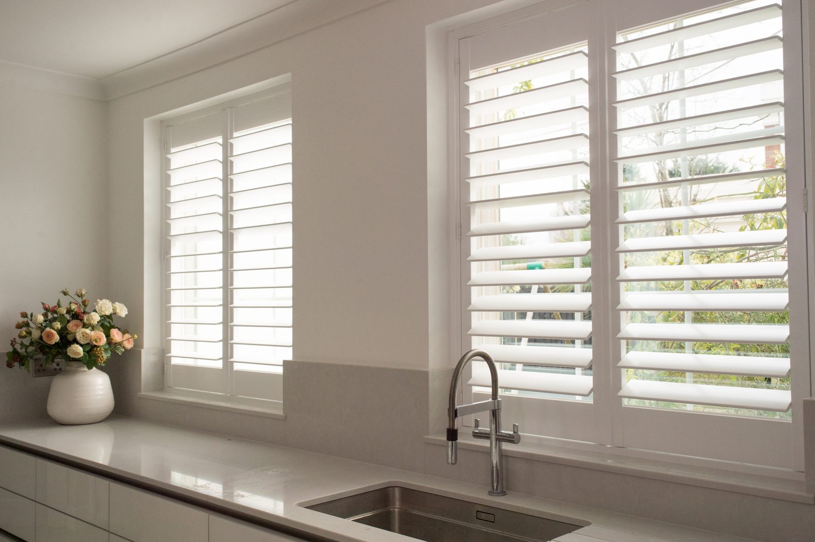 White plantation shutters above a Suffolk kitchen sink