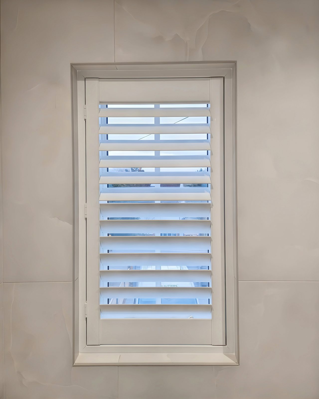 Small bathroom window shutters in an Ipswich home