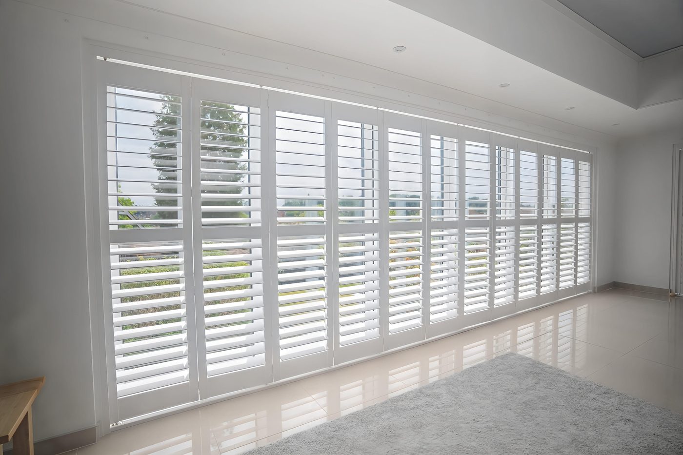 Endura shutters across a wide living room window run