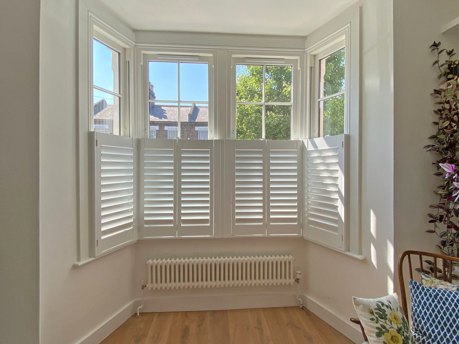 Living room bay window shutters in a Suffolk home