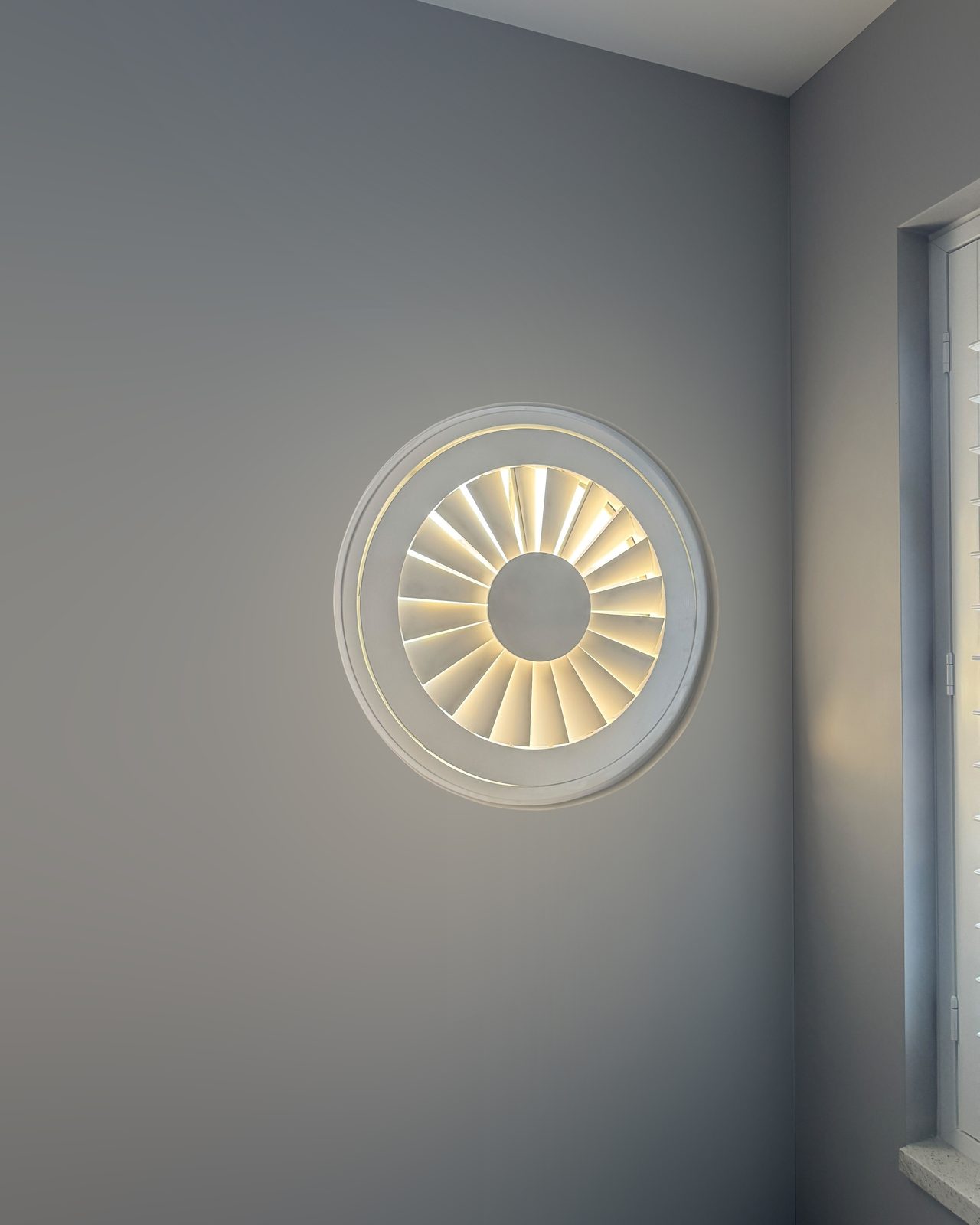 Round window shutters fitted in a Suffolk home