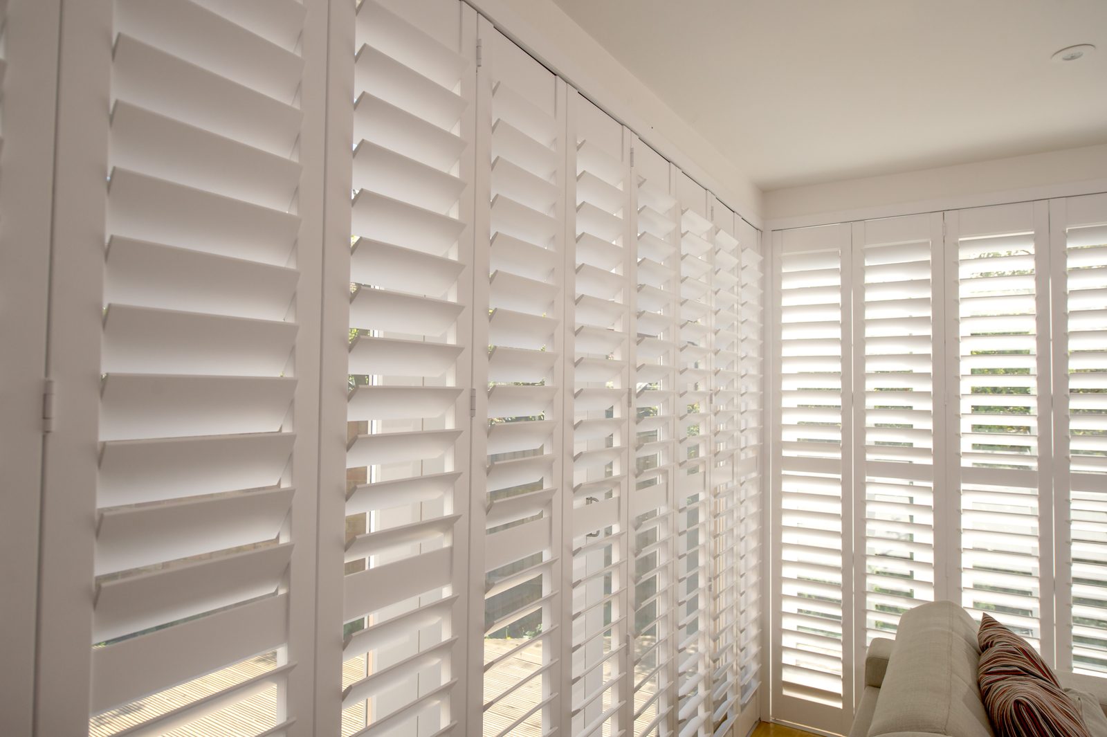 Full height shutters across a living room window in Ipswich